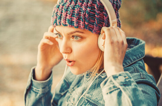 Relax in park. Hipster girl relax in park with mp3 player. Hipster woman in headphones relax in park. Listening music outdoor. audio book. Outdoors portrait of a trendy girl.