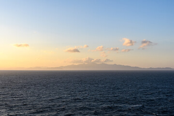 Coast of Costa Rica in dawn light against the background of clouds.