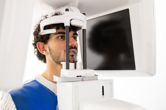 Man undergoing dental panoramic x-ray in clinic - Powered by Adobe