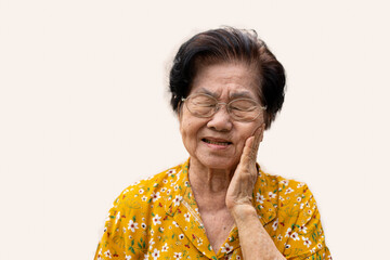 Asia old senior woman suffering from severe toothache, holding her cheek and suffering strong...