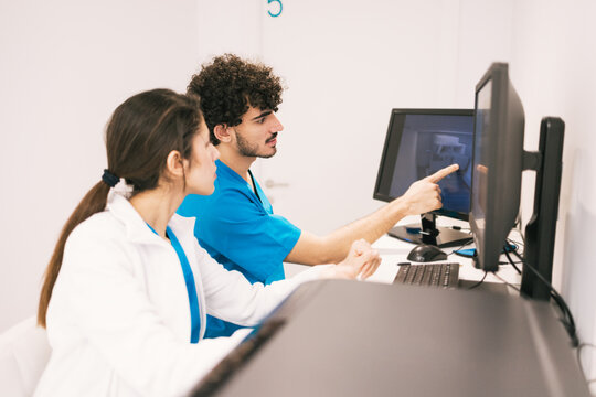 Medical professionals analyzing data on computer screen