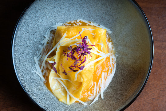 Cheese and walnuts tortellini with grated cheese on top