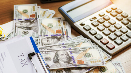 Calculating numbers for income tax return with pen and calculato, Calculator with text Tax Saving....