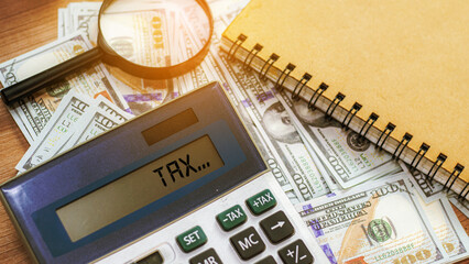 Calculating numbers for income tax return with pen and calculato, Calculator with text Tax Saving....