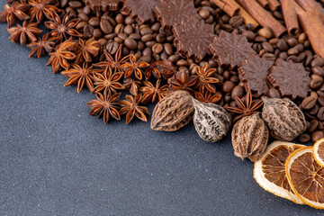 Food background. Coffee beans, cinnamon sticks, anise stars and chocolate candies top view.