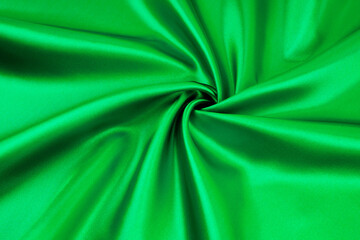 Closeup of elegant shiny green silk texture.