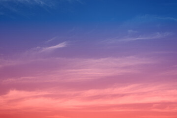Early morning light sky before sunrise. Soft purple, pink and orange light on the horizon. Empty natural sky with colorful pastel tone colors for background. Vivid colors in modern mood.