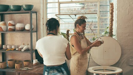 Pottery, store and people check cup, ceramic clay design or mold for quality assurance in manufacturing process. Electric kiln, startup small business and team inspection of handmade retail product