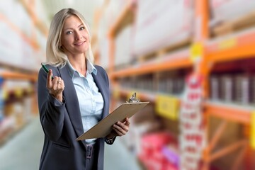 Portrait of young woman auditor work do inventory in warehouse