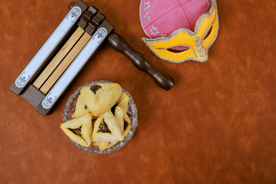 Carnival mask, hamantaschen cookies, noisemakers, were used to celebrate Jewish holiday of Purim