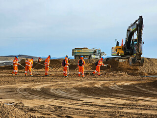 Excavator type construction machinery working on bulk earthworks  in a mine.