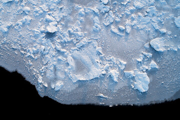 An aerial of a ice on a river covered with some snow and texture in rural Estonia, Northern Europe