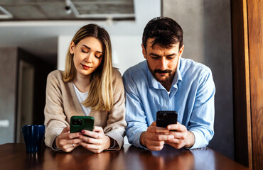 Gadget addiction and relationship problems. Couple with smartphones ignoring each other