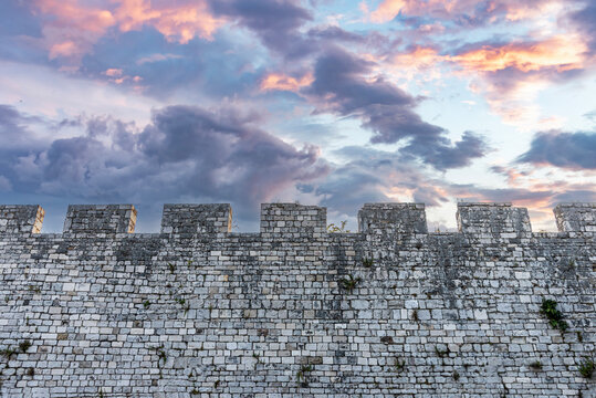 Stone wall of a castle against the sky.