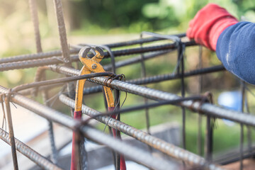 Pincer hanging on iron structure construction site with hand worker working 