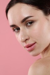 Fototapeta premium Portrait of beautiful young woman on pink background