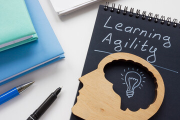 Notepad with inscription learning agility and head model.