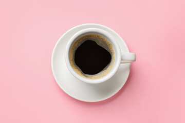 Fresh coffee in cup on pink background, top view