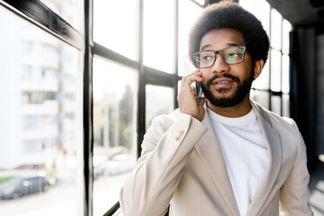Brazilian businessman is actively engaging in a conversation on the phone, with a look of earnest...