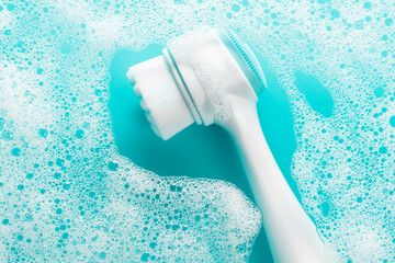 Brush for washing and cleaning the face with soap foam. Hygienic device. Female beauty.