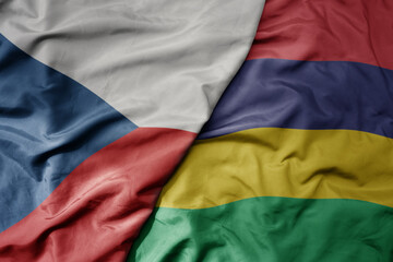 big waving national colorful flag of mauritius and national flag of czech republic.