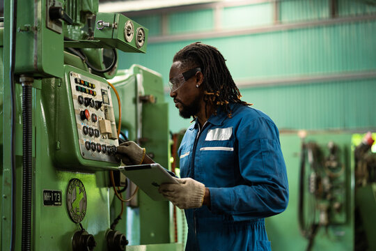 Black male mechanical engineer working at metal lathe factory Machine lathe operating engineer African American people.