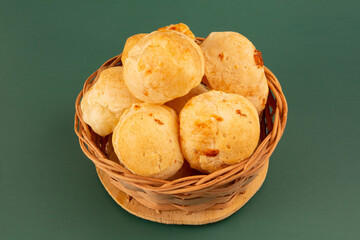 Cheese bread (Brazilian pao de queijo mineiro) in front view, clean background wooden basket