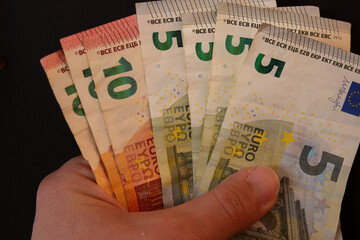 Hand holding euro bills. Closeup photo.