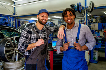 Two mechanic colleagues of different races, bonded by smiles, showcasing the beauty of diversity in...