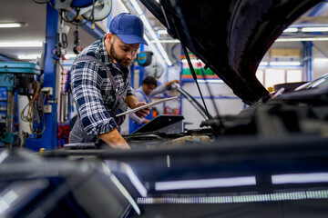 In the workshop, a mechanic utilizes a tablet for diagnostics and parts availability, seamlessly blending traditional expertise with modern technology.