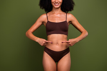 Cropped no filter photo of smiling happy girl showing her tummy healthy diet slimming isolated on...