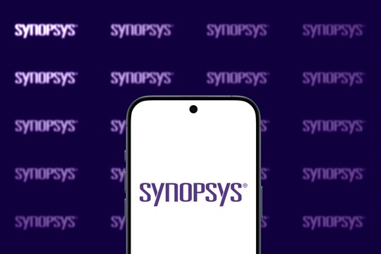 Synopsys Logo is displayed on a modern smartphone, tools and services to the semiconductor design and manufacturing industry, synopsys logos on a dark purple background, processors, ai, cloud