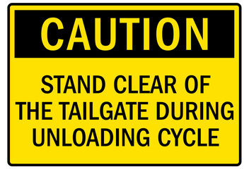 Truck warning sign and labels stand clear of the tailgate during unloading cycle
