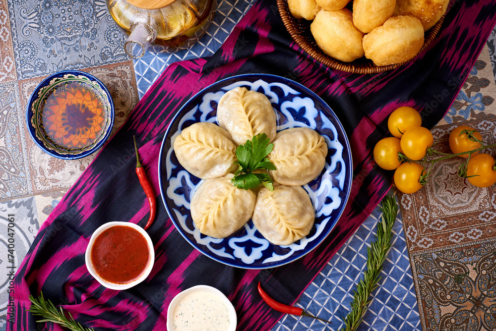 Wall mural Manti with tea and bread. Oriental background