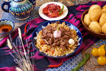 Uzbek food. Pilaf of rice and meat. oriental background
