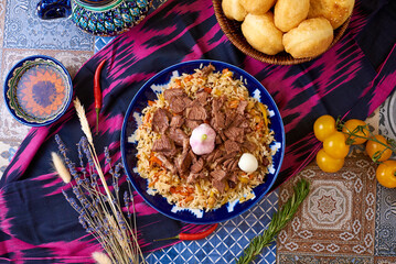 Uzbek food. Pilaf of rice and meat. oriental background