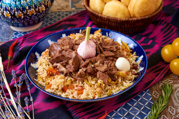 Uzbek food. Pilaf of rice and meat. oriental background