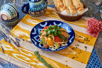 Lagman with vegetables and meat. Oriental background