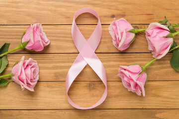 Composition with pink roses and eight made of ribbon on wooden background, top view. Women's day concept