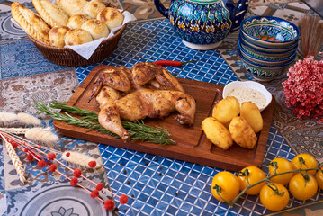 Fried chicken with potatoes and sauce. Oriental background