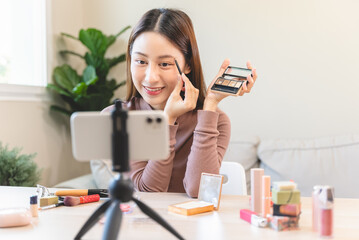 asian female beauty social media influencer livestream marketing cosmetics a make up tutorial via...