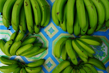Cluster of fresh green and yellow bananas at a market in Tahiti, French Polynesia