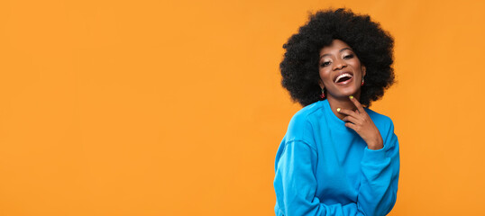 Obraz na płótnie Canvas Happy African American woman in blue sweatshirt.