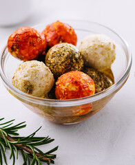 Small balls of goat cheese rolled in different spices