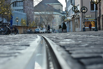  City Tramway and Bicycle Parking by Cobblestone Street with Cafe in Germany - 740059856