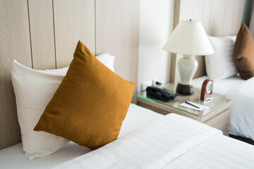A freshly made bed with pillows and cushions, soft cushions on white bed.