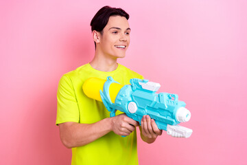 Photo portrait of nice teen man point hold water gun shopping poster dressed stylish yellow clothes...
