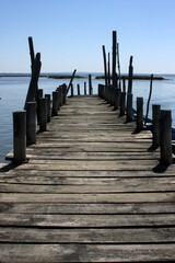 Fototapeta premium Idyllic Palafitic Pier in Setúbal, Portugal, where traditional architecture reflects in the calm waters of the bay. Charming scene for authentic visual projects.