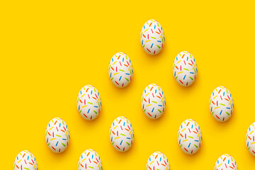 Sprinkle painted easter eggs on yellow background