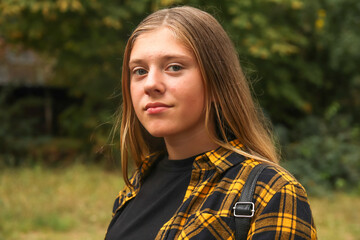 Portrait preteen girl on the green nature background. Girl 15 years